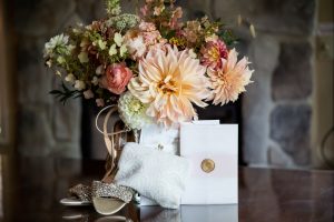 wedding blooms with invitation